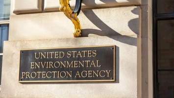 United States Environmental Protection Agency bronze plaque on a stone building with gold metalwork above